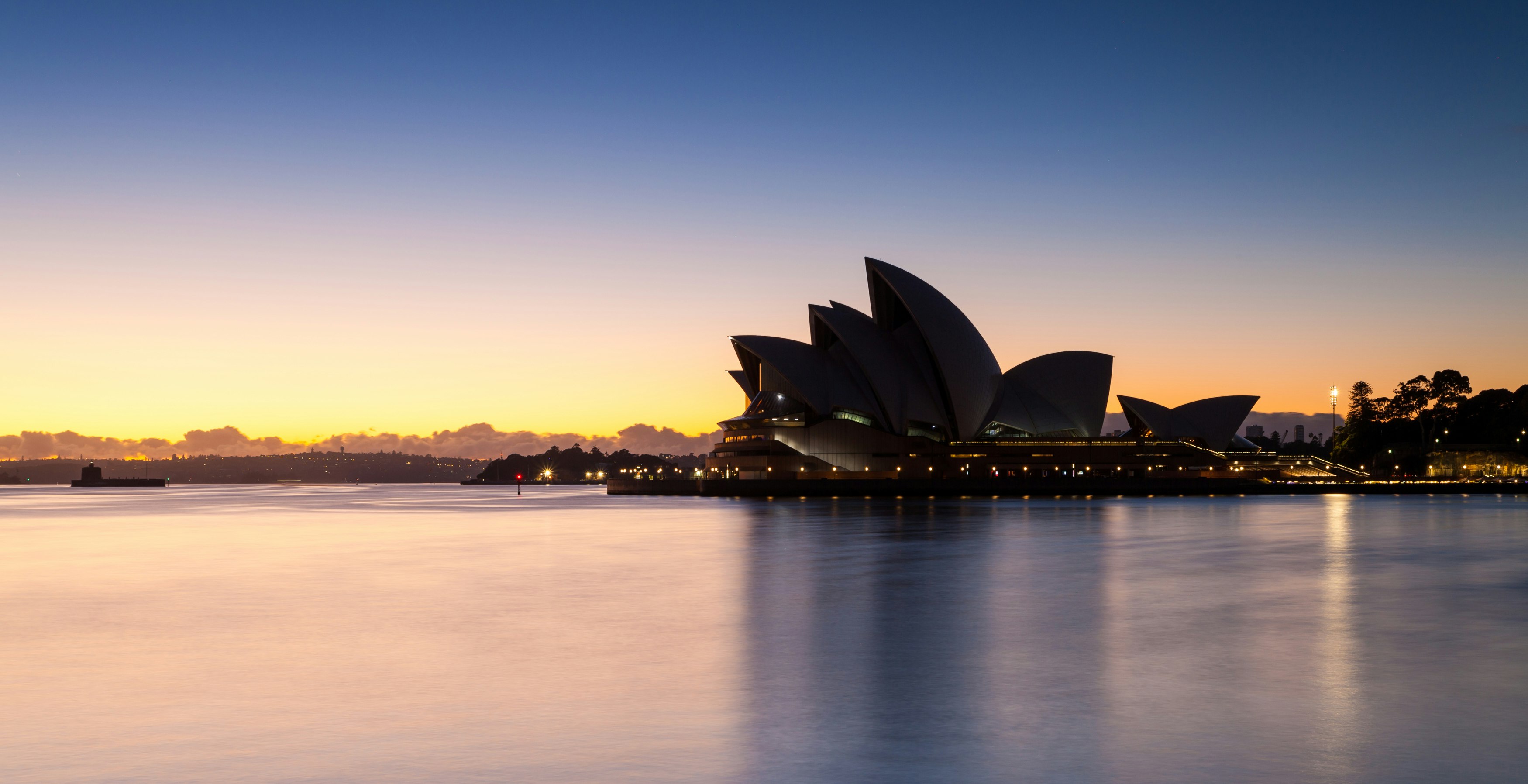 sydney opera house near body of water during sunset
